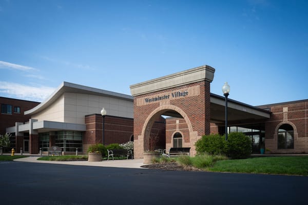 Front entrance of Westminster Village with landscaping