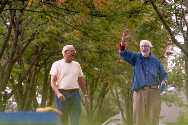 Two senior men enjoying time outdoors in a park