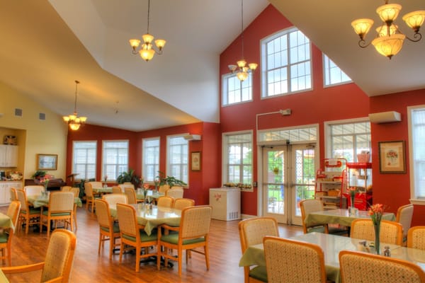 Bright dining room with large windows and tables