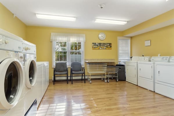 Laundry room with washing machines and seating area