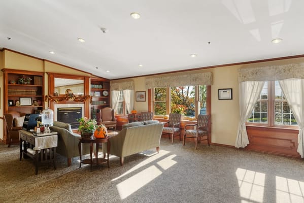 Bright living room with seating and a fireplace