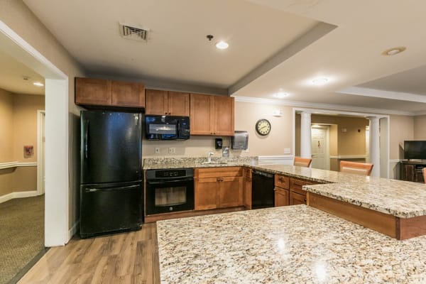 Spacious kitchen with granite countertops and appliances