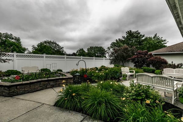 Outdoor garden area with benches and flowering plants