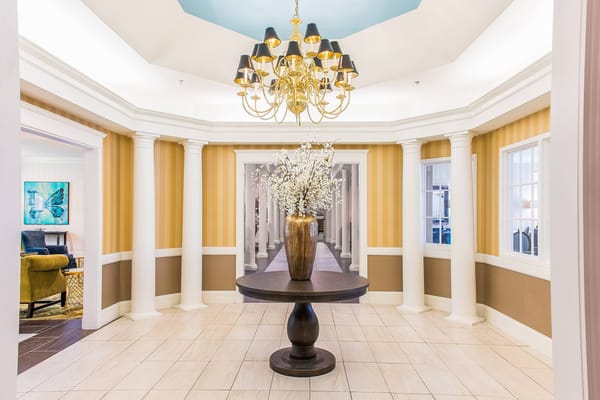 Elegant interior lobby with a chandelier and flower arrangement