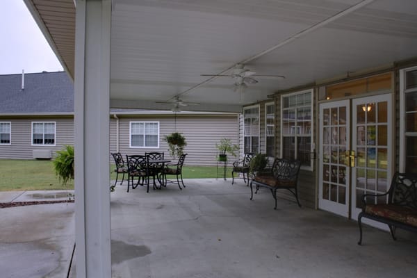 Covered outdoor seating area with tables and chairs