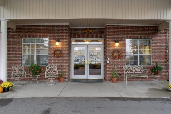 Front entrance of a senior living facility with flower decorations