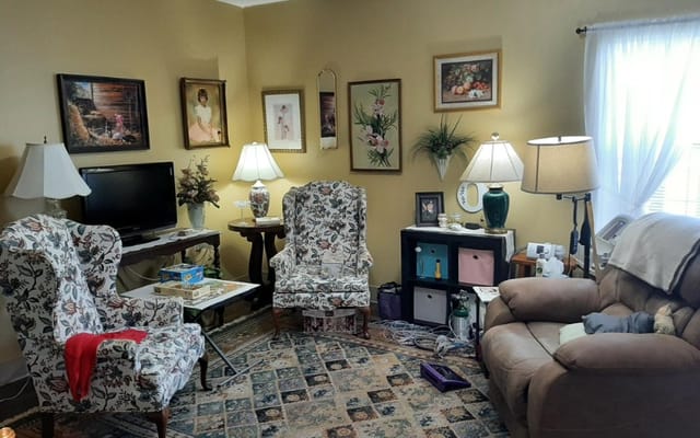 Cozy living room with floral chairs and artwork
