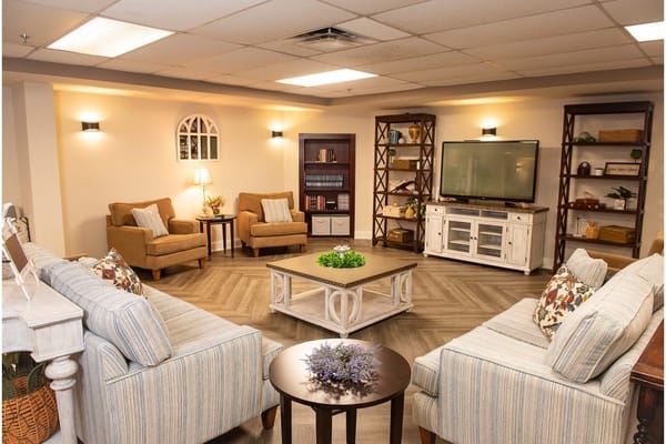 Spacious living area with comfortable seating and a television.