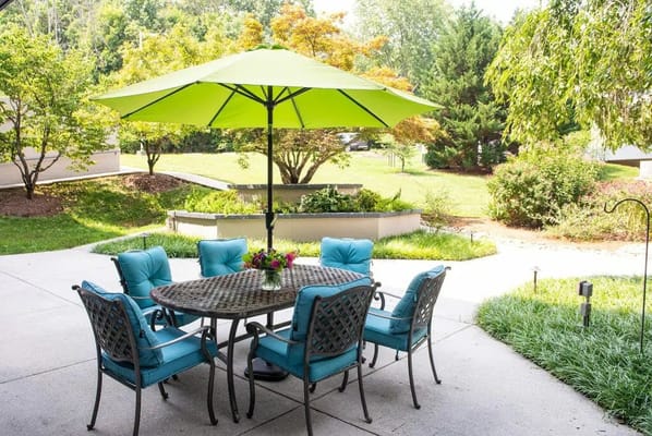 Outdoor seating area with vibrant umbrellas and plants