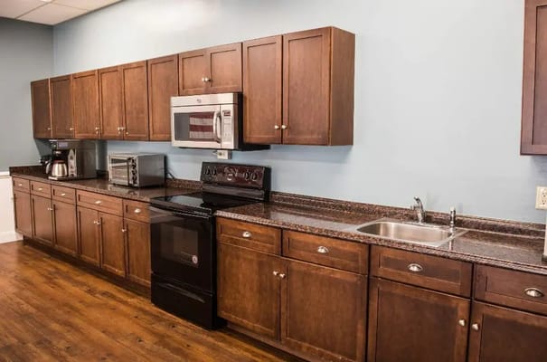 Interior kitchen space with wooden cabinets and appliances