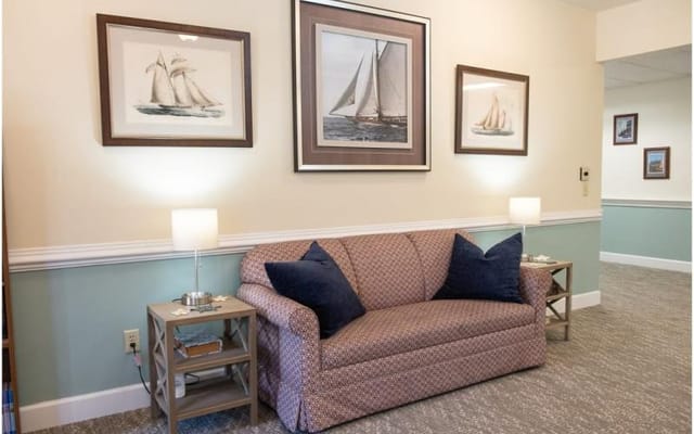 Comfortable seating area with nautical artwork