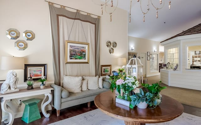 Interior view of a welcoming common area with floral arrangements
