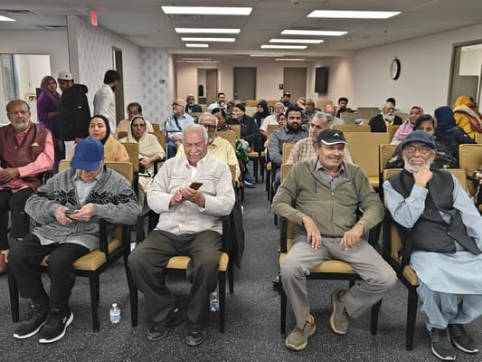 Residents enjoying a social event in a spacious room.