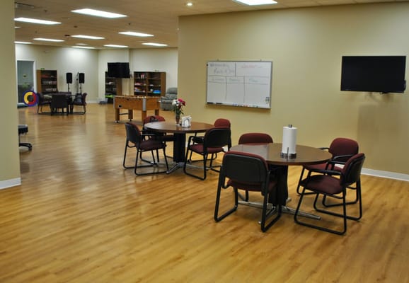 Bright common area with tables and chairs set up