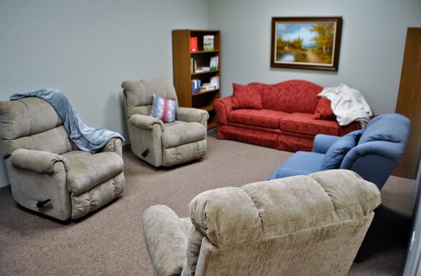 A cozy common area with recliners and a couch