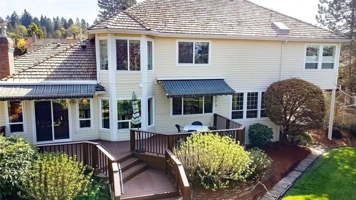 Outside view of Alpine Fairways Care Home featuring a deck and garden.