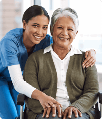 A caregiver and a resident smiling together indoors