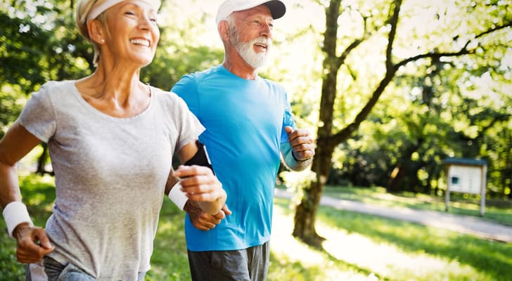 Senior couple jogging together in a park