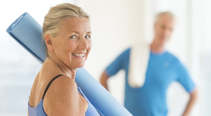 Seniors engaging in a yoga session with mats