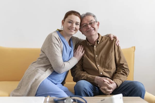 Caregiver and resident sharing a moment on a couch