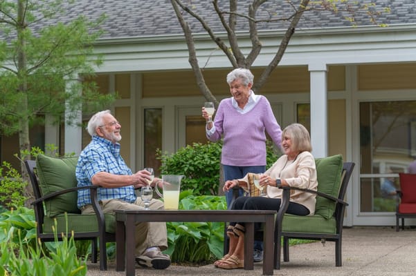 Residents enjoying drinks in an outdoor seating area