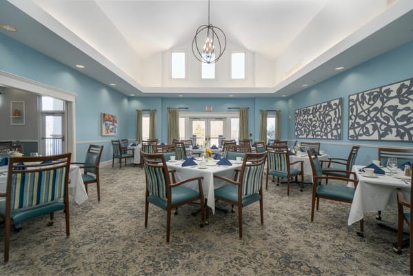 Bright dining room with tables set for meals