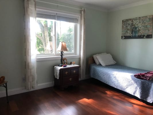 Cozy private resident room with a bed and lamp