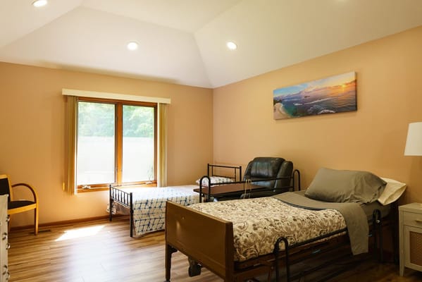A cozy shared bedroom with two beds and natural light