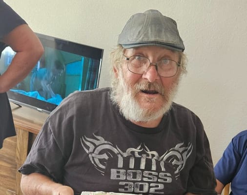 A resident enjoying a meal indoors