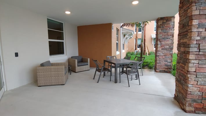 Outdoor seating area with a table and chairs.