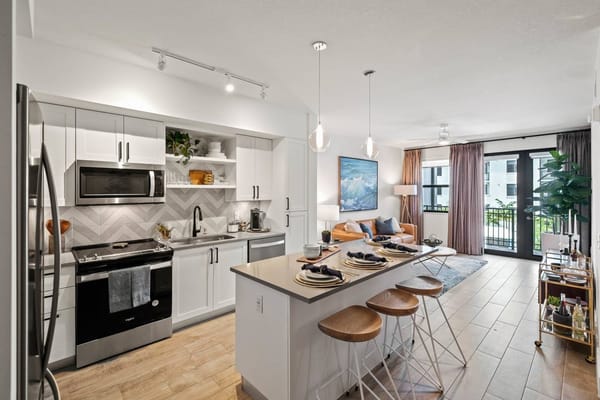 Spacious kitchen and living room area with modern decor.