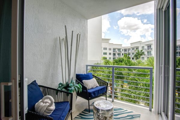 Balcony with seating overlooking tropical plants