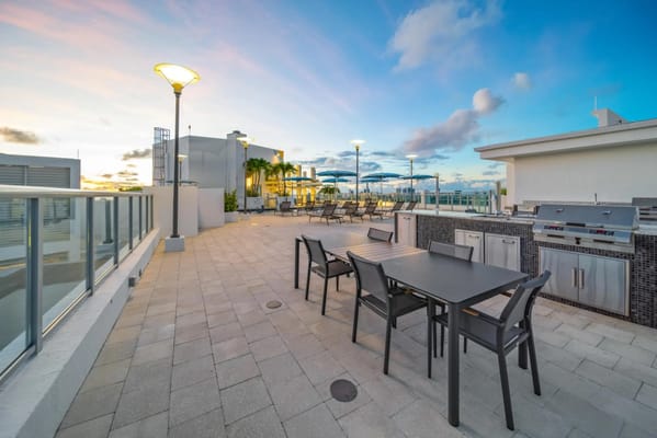 Outdoor patio area with seating and grills