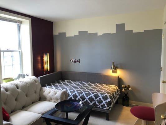 A cozy interior room with a bed and couch