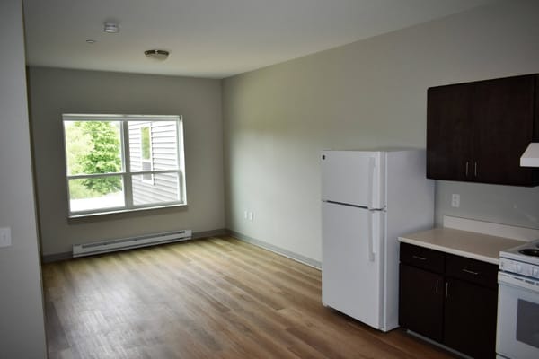 An interior photo of a resident room with a kitchen area