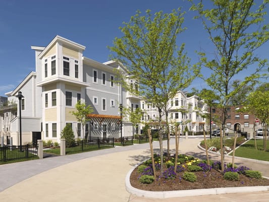 Exterior view of a senior living facility with landscaped gardens
