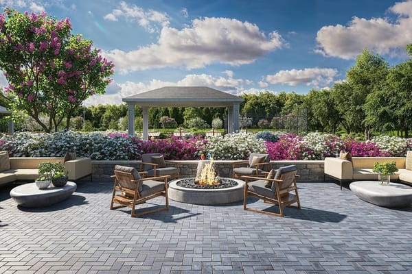 Cozy outdoor patio featuring a fire pit surrounded by blooming flowers.