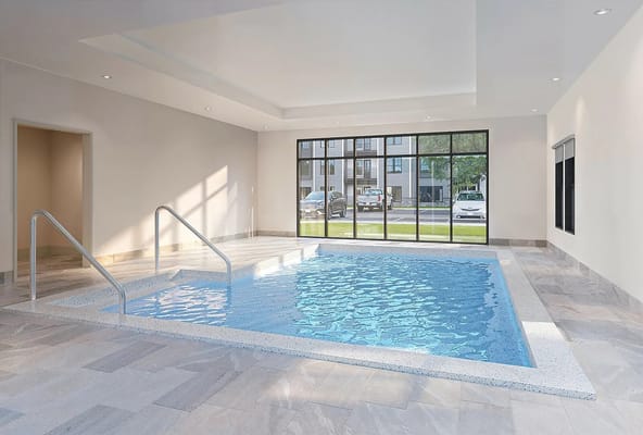 Indoor swimming pool with steps and large windows
