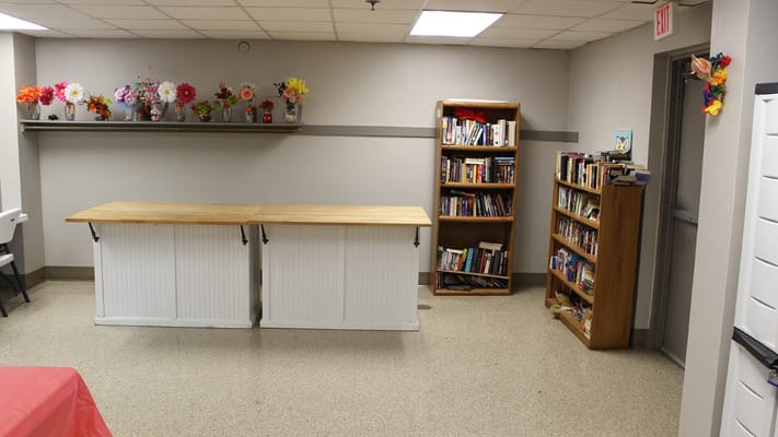 Interior activity room with bookshelves and decorations