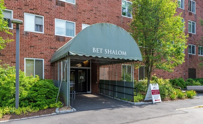 Entrance canopy of Bet Shalom Senior Apartments with signage.