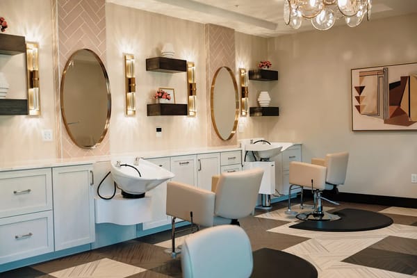 Interior view of a salon area with seating and mirrors