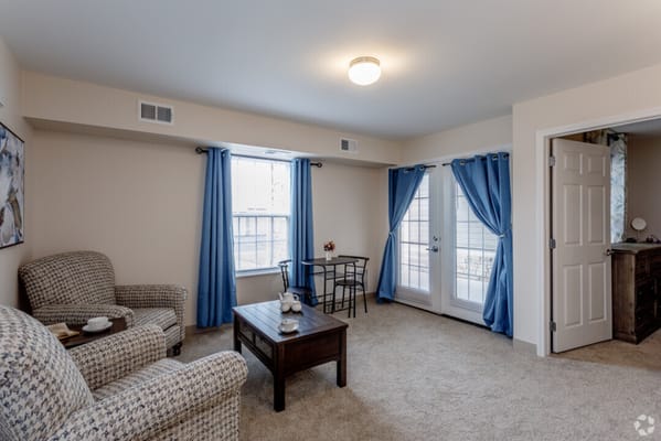 Bright, furnished resident room with table and chairs