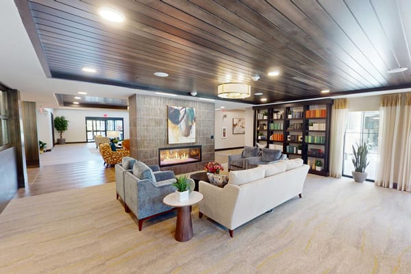 Cozy lounge area with a fireplace and bookshelves