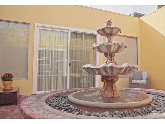 A decorative fountain in an outdoor courtyard