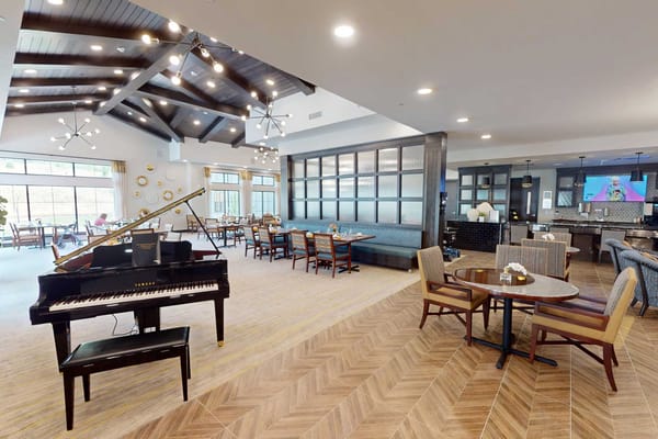 Interior view of a common area with seating and a piano