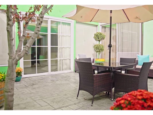 Outdoor patio area with seating and plants