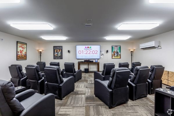 Cozy movie theater room with recliner seating