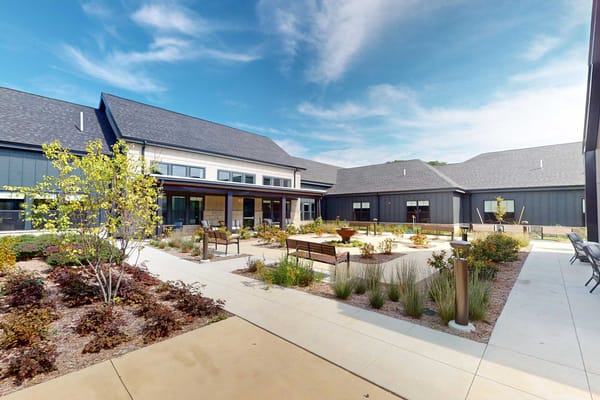 Outdoor courtyard area with seating and landscaping