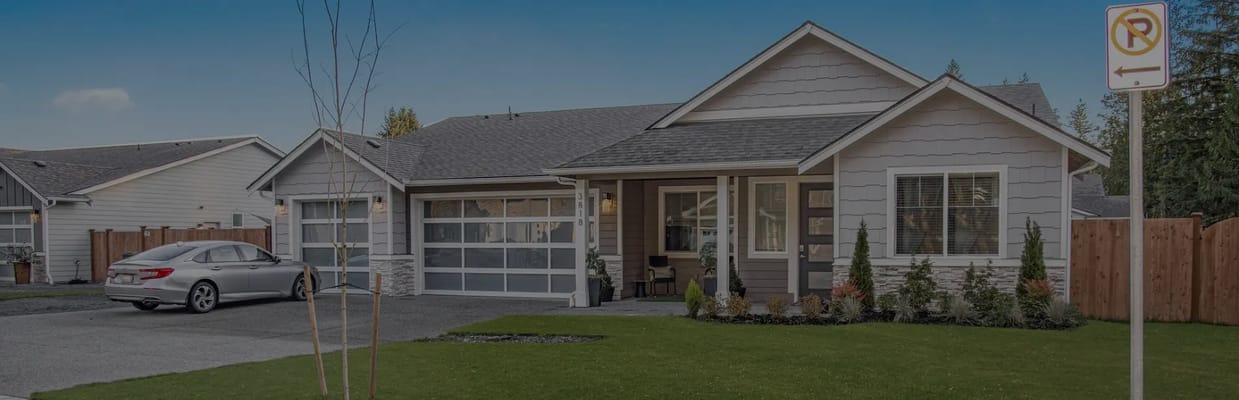 Exterior view of a senior living facility with a landscaped yard