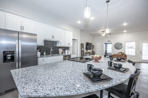 Bright common area with kitchen and dining setup